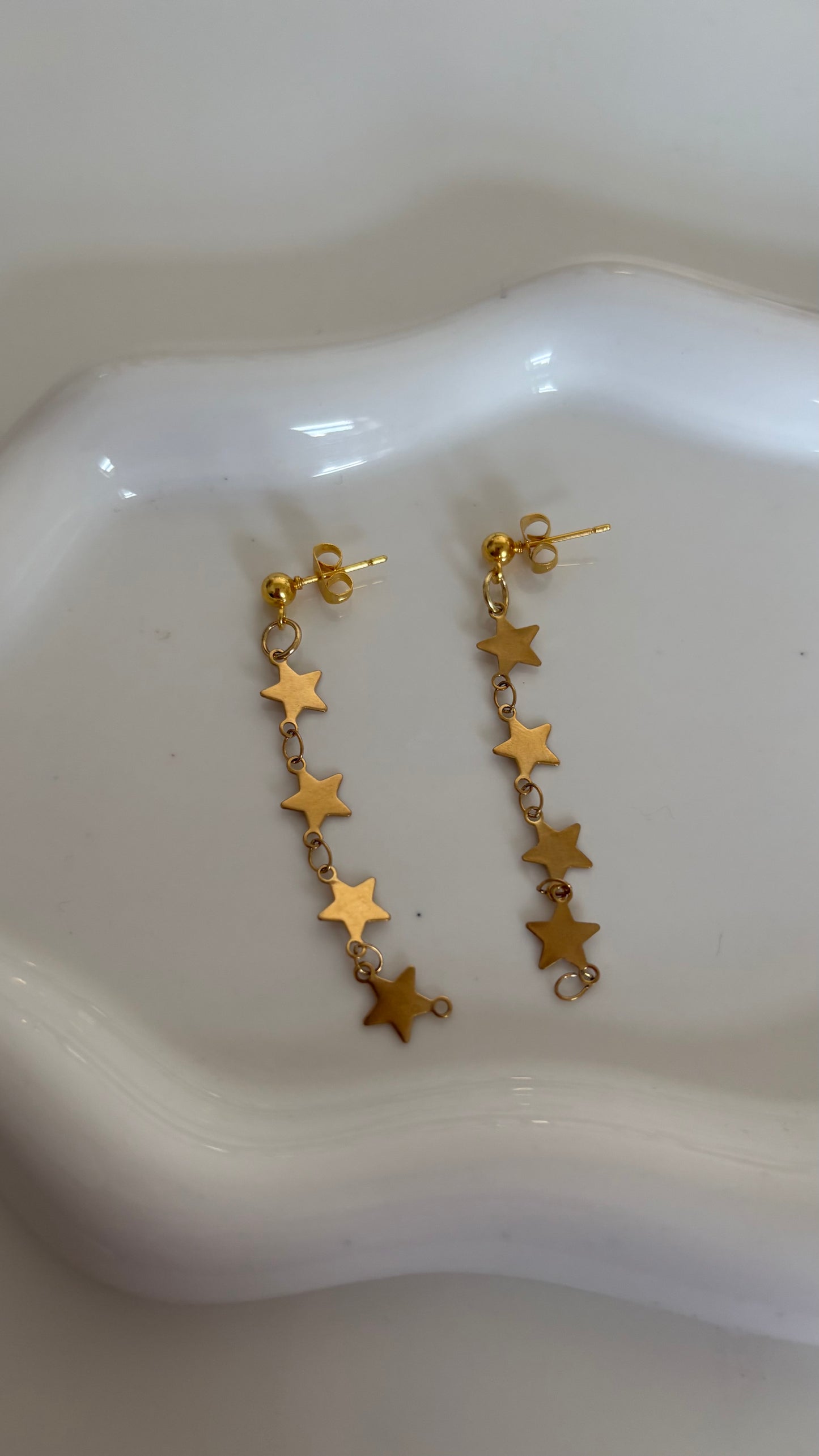 Gold star dangle earrings